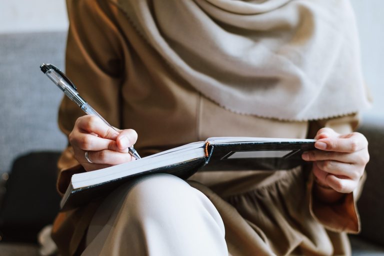 Muslim, woman, writing — Protect Your Platform Using Real-Time Identity Verification