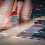 Data security breach detected with futuristic red warning flags superimposed on programming scripts. Programming logic interface with multiple error alerts at a developer's workspace with a laptop