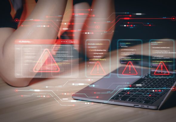 Data security breach detected with futuristic red warning flags superimposed on programming scripts. Programming logic interface with multiple error alerts at a developer's workspace with a laptop