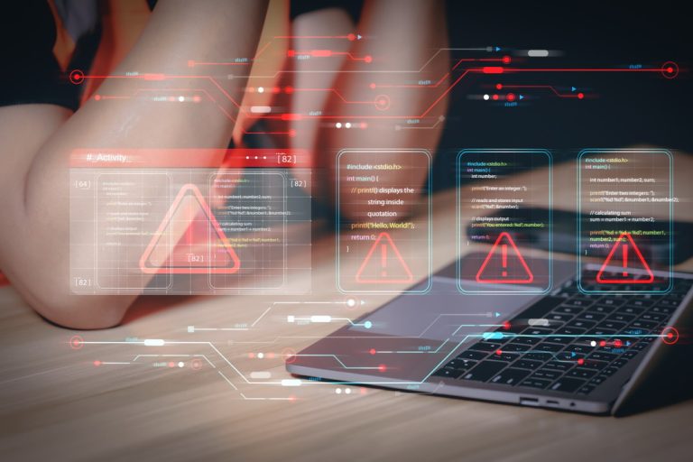 Data security breach detected with futuristic red warning flags superimposed on programming scripts. Programming logic interface with multiple error alerts at a developer's workspace with a laptop